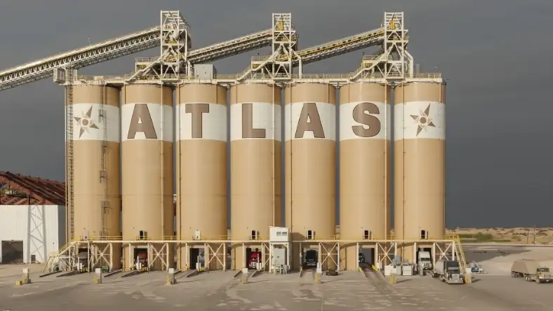 Atlas Energy sand storage silos at an industrial facility